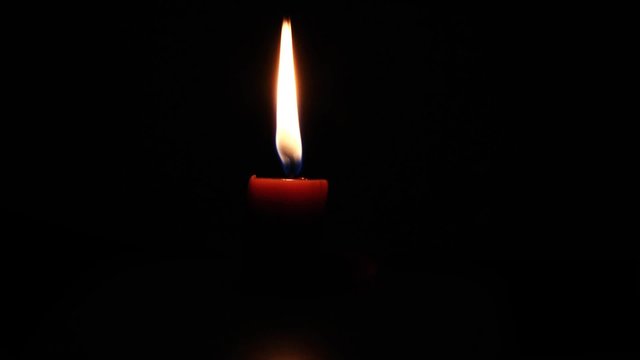 Candle burning down - time lapse / Black background