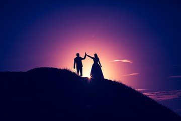 Vintage photo of wedding couple silhouettes in outdoor