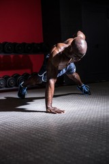 Fototapeta premium Young Bodybuilder doing One-armed push ups