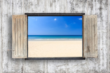Old wooden windows frame on cement wall and view of sea