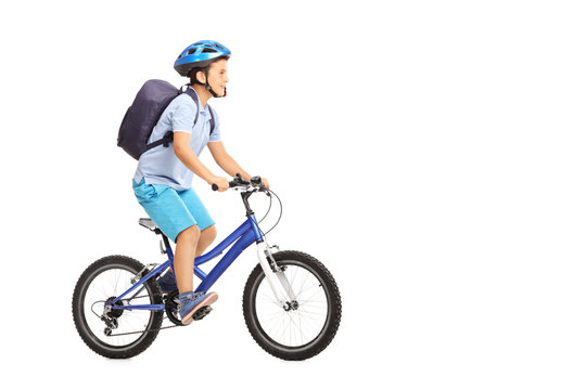Schoolboy with a helmet riding a bike