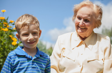 Positive grandmother and grandson spent time together in summer solar garden.
