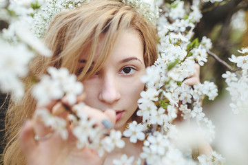 Portrait of a beautiful girl flowering trees