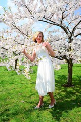 Beautiful female posing in the sakura garden