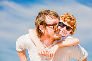 Hipster father with beard and red haired son having happy summer
