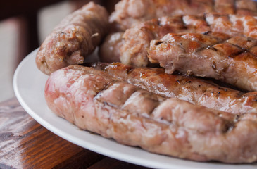 Grilled sausages closeup on a plate