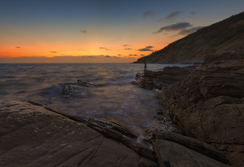 Stone beach and sunset at rayong beach ,Thaoland