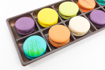 Macaron in tray on white background.