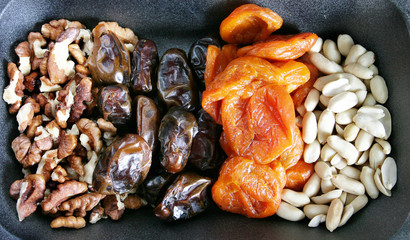 nuts and dried fruits on black background