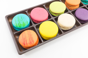 Macaron in tray on white background.