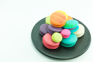 Macaron in plate on white background.