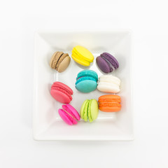 Macaron in plate on white background.