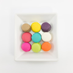 Macaron in plate on white background.