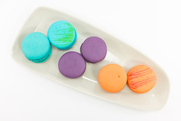 Macaron in plate on white background.