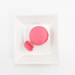 Macaron in plate on white background.