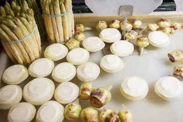 Peeled organic celery and asparagus at the market/Fresh peeled vegetables at the market.