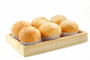 Fresh buns on a wooden tray isolated