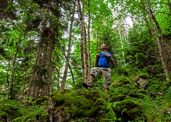 Fototapeta na wymiar Active healthy man hiking in beautiful mountains forest