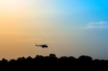 Fototapeta na wymiar Helicopter at sunset