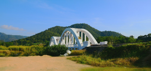 Fototapeta na wymiar old arch bridge across the creek in LAMPHUN THAILAND. White colo