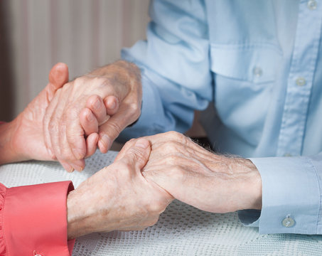 Old people holding hands closeup. Elderly couple.
