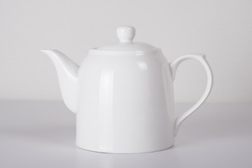 white ceramic teapot on white background
