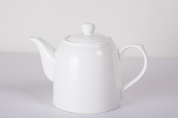 white ceramic teapot on white background	