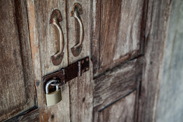 locked wooden door with metal padlock