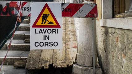 sign under renovation in Italian