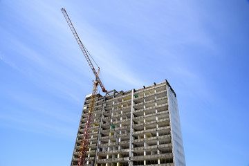 demolition of a skyscraper with a high crane