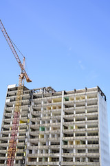 Fototapeta premium demolition of a skyscraper with a high crane
