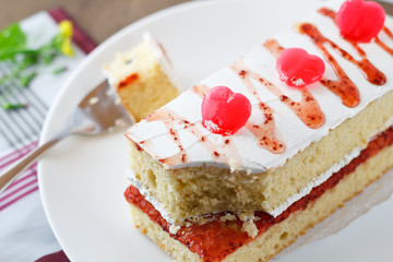 Strawberry cake with heart candies for sweet valentines.