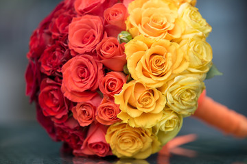 Elegant bride flowers with red, yellow and orange roses.