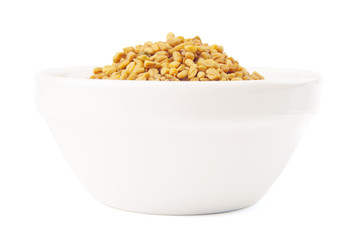 Fototapeta na wymiar Fenugreek seeds in white bowl 