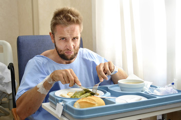 moody face patient in hospital room eating healthy diet clinic food upset 