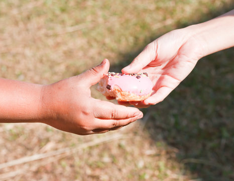 giving a donut to a child.