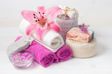 Obraz na płótnie Canvas Pink lily flower,sea salt, towels,shoap and objects for spa pro