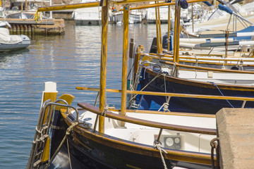 Fototapeta na wymiar Fishing small white boats tied on a pier