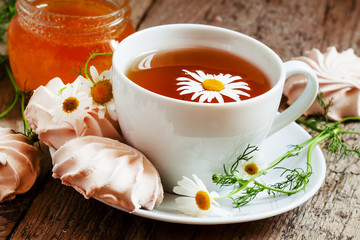 Black tea with chamomile, honey and marshmallow, selective focus