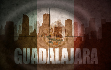 sniper scope aimed at the abstract silhouette of the city with text Guadalajara at the vintage mexican flag © luzitanija