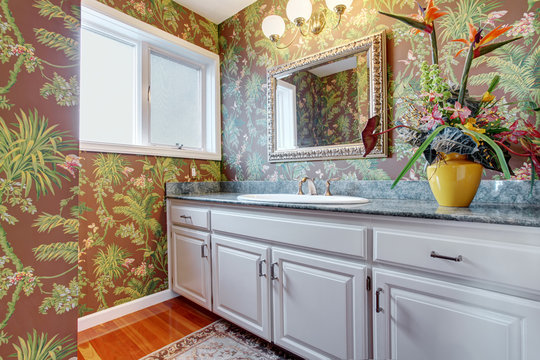 Coloful bathroom with floral walls and white hints.