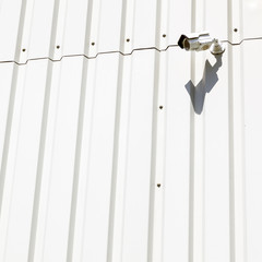 surveillance camera on wall of industrial building