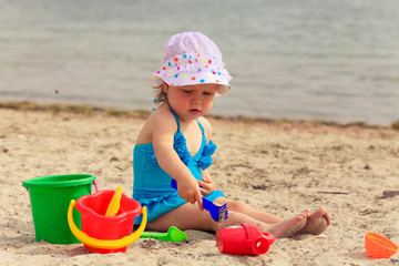 Child playing with toys at beach in summer