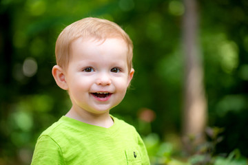 Portrait of happy smiling toddler playing outdoors