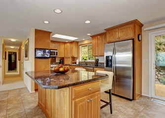 traditional kitchen with island and tile floor.