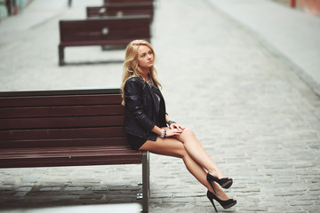 Attractive Smiling Young Adult Female sitting on a bench in Lviv