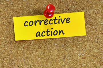 corrective action  word on notes paper with cork background