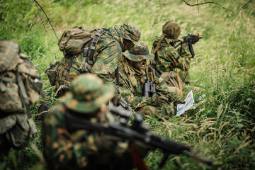 Ranger commander explains the combat mission and points to a  ma