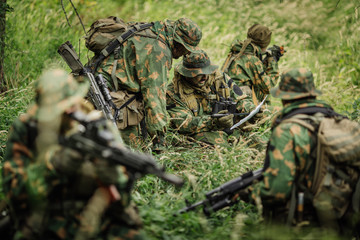 Ranger commander explains the combat mission and points to a map