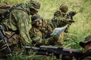 Ranger commander explains the combat mission and points to a map